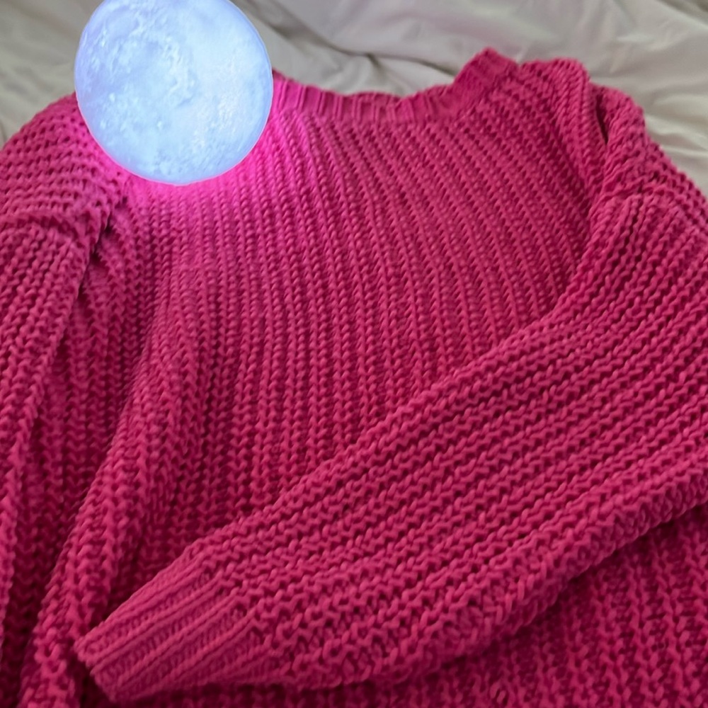 Hot pink knitted sweater.